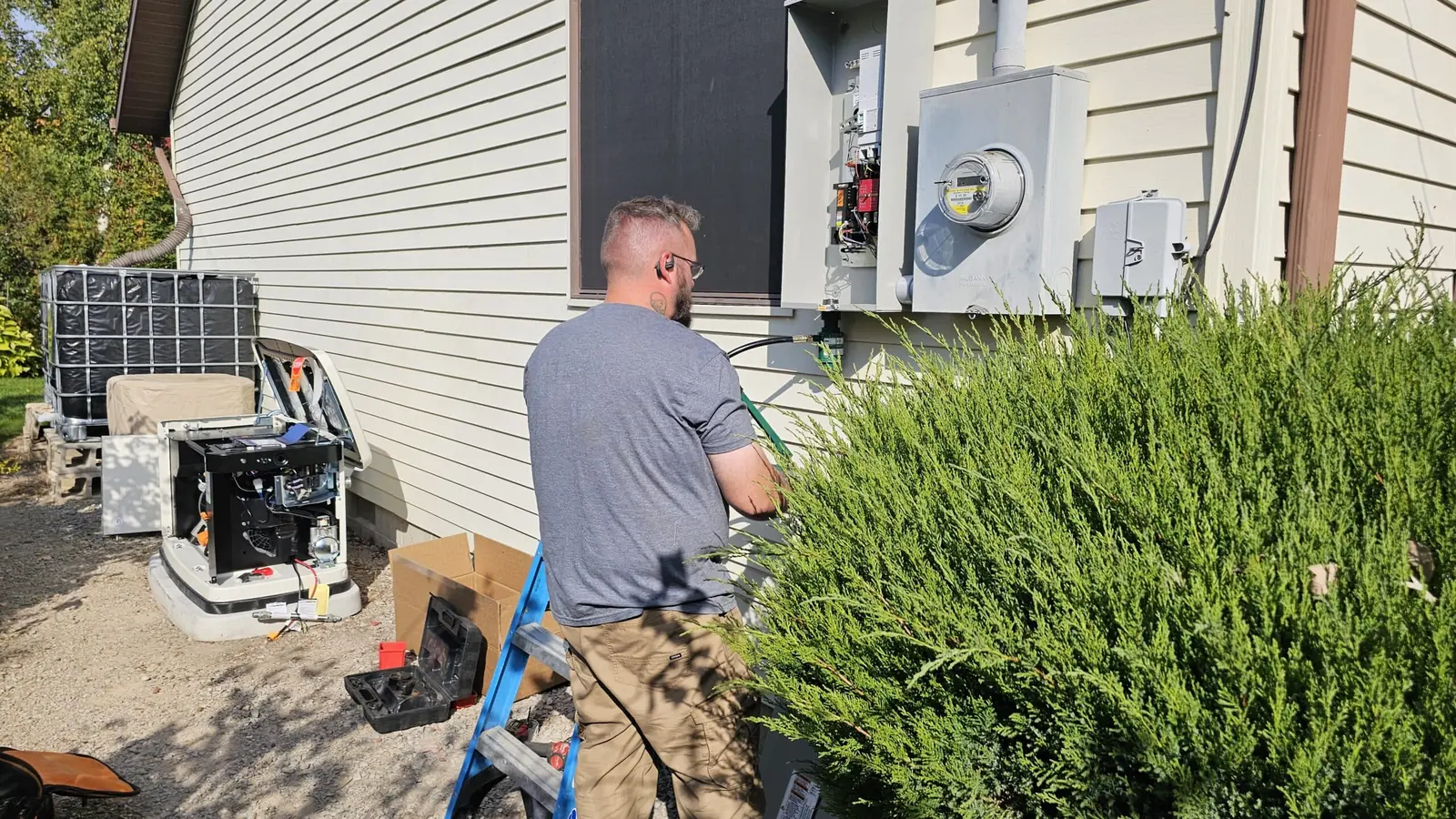 Two Axiom electricians working on a meter base and service entrance
