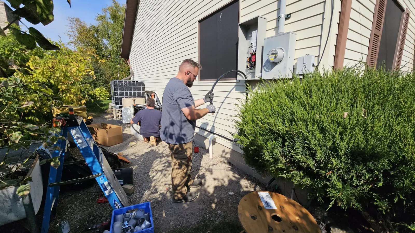 Axiom Electrical Services crew replacing an electrical service